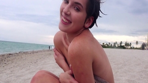 Cumshot at the beach accompanied by small tits brunette